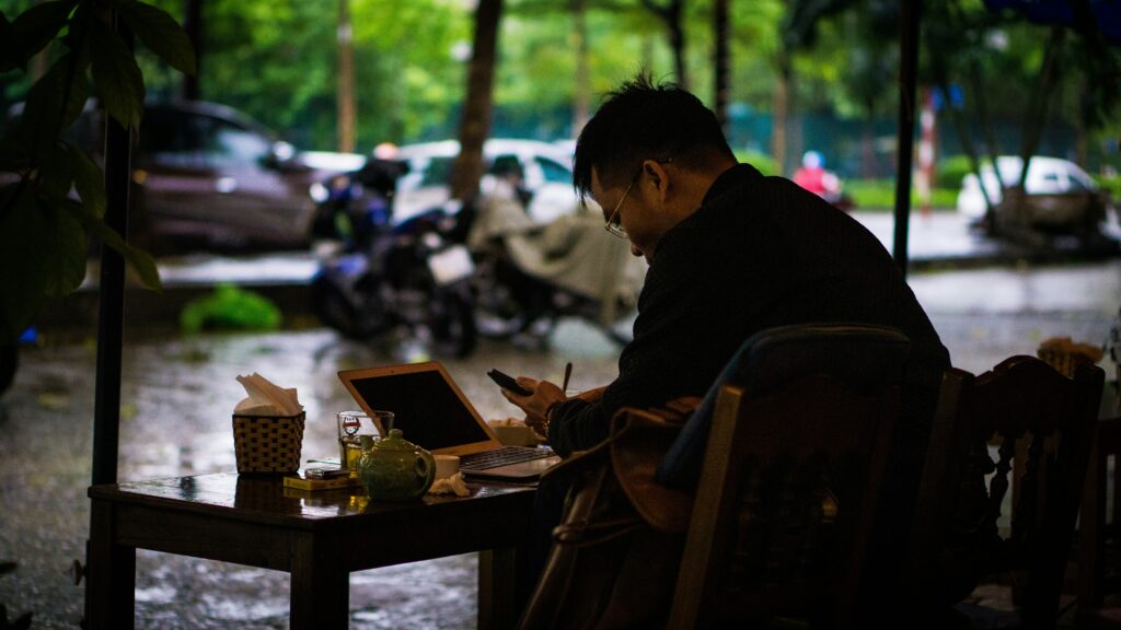 Guy sitting at table journaling working on his self discipline, through Stoicism.