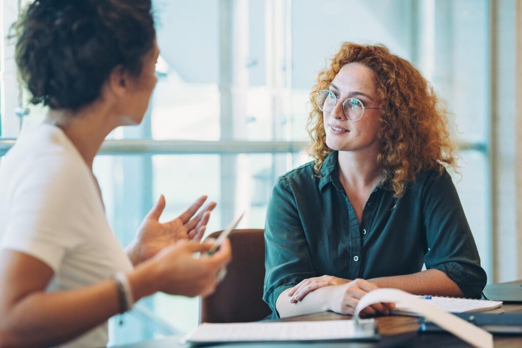 Two colleagues having a calm, respectful conversation at work.