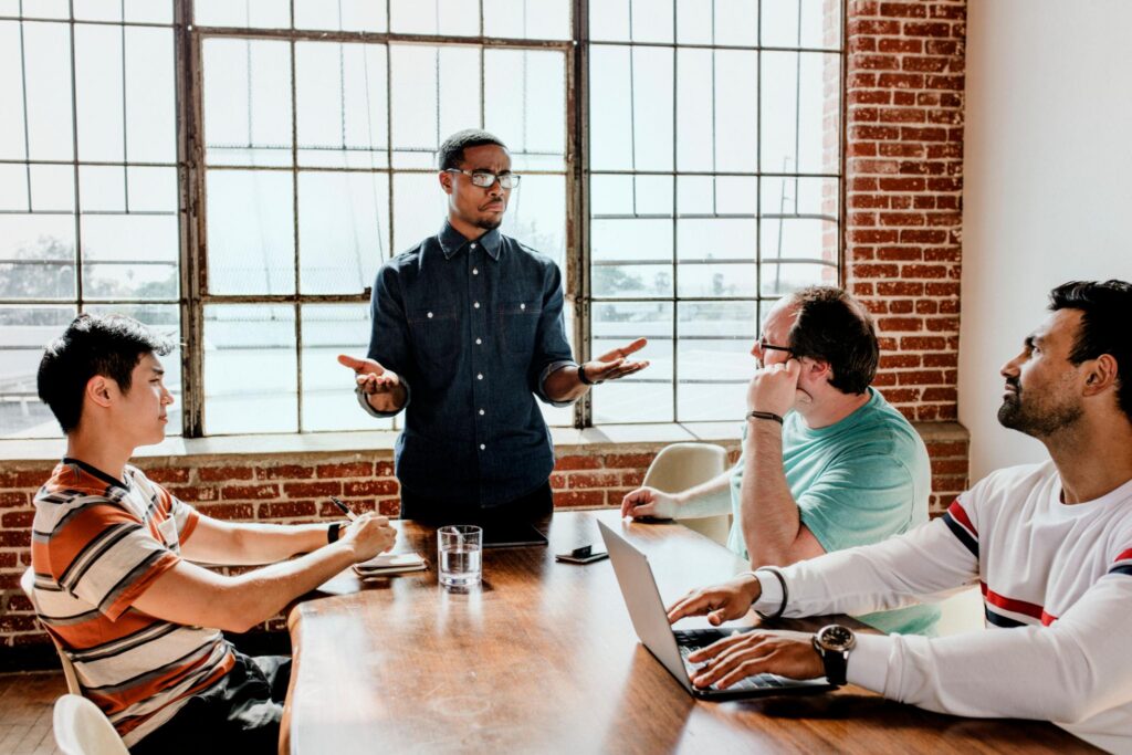 A team member sharing a different perspective during a leadership discussion.