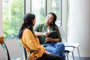 Leader listening during a coaching conversation instead of immediately providing the answer.